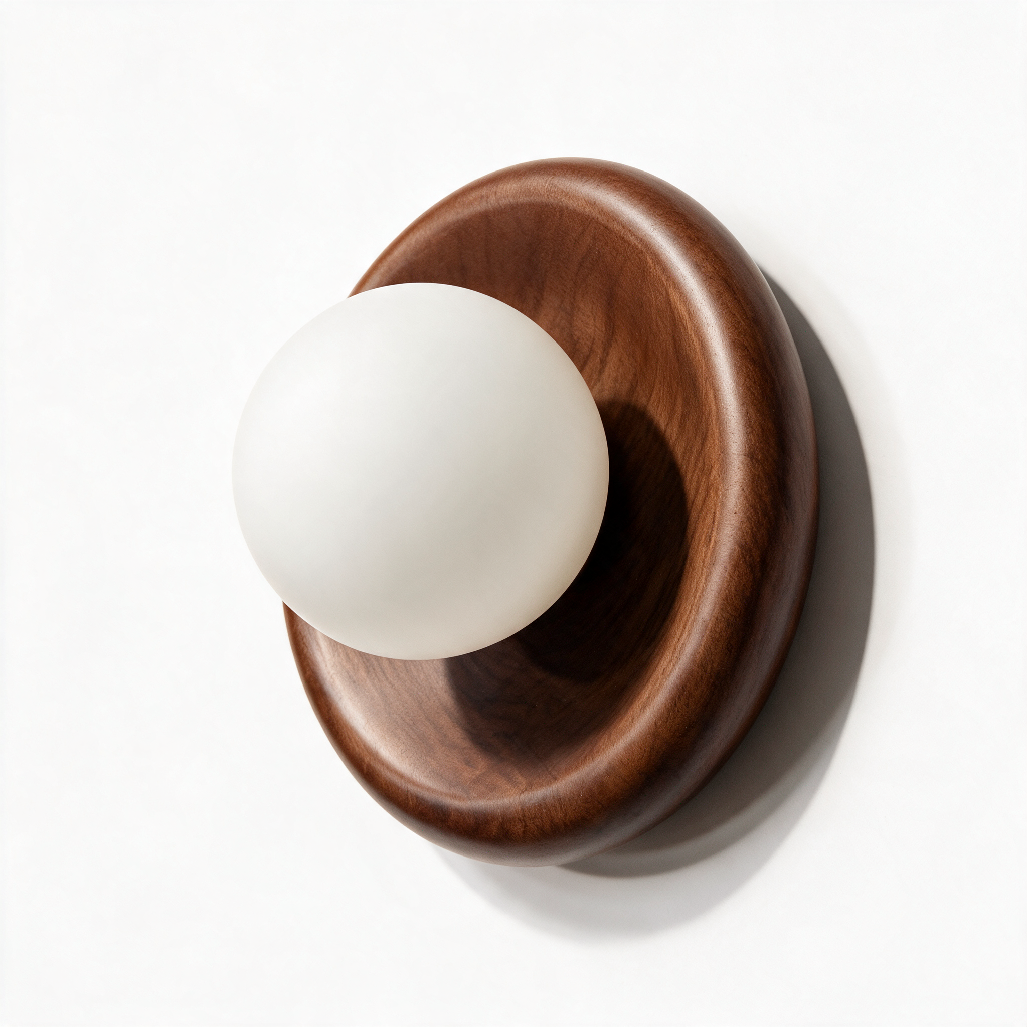 Marlow walnut wall sconce with frosted glass shade, three-quarter view on white background