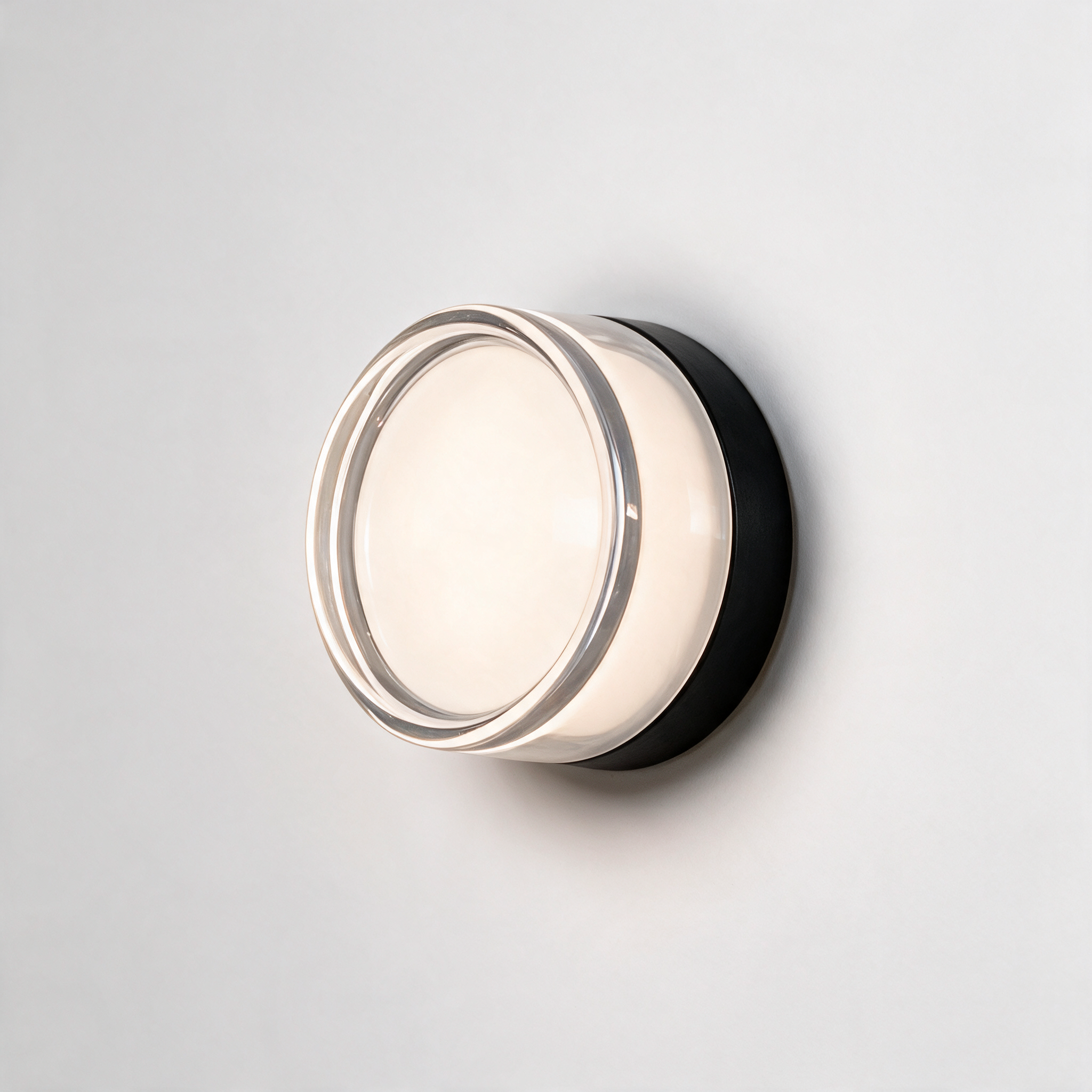 NOOR Wall Sconce, round with white shade on a black base