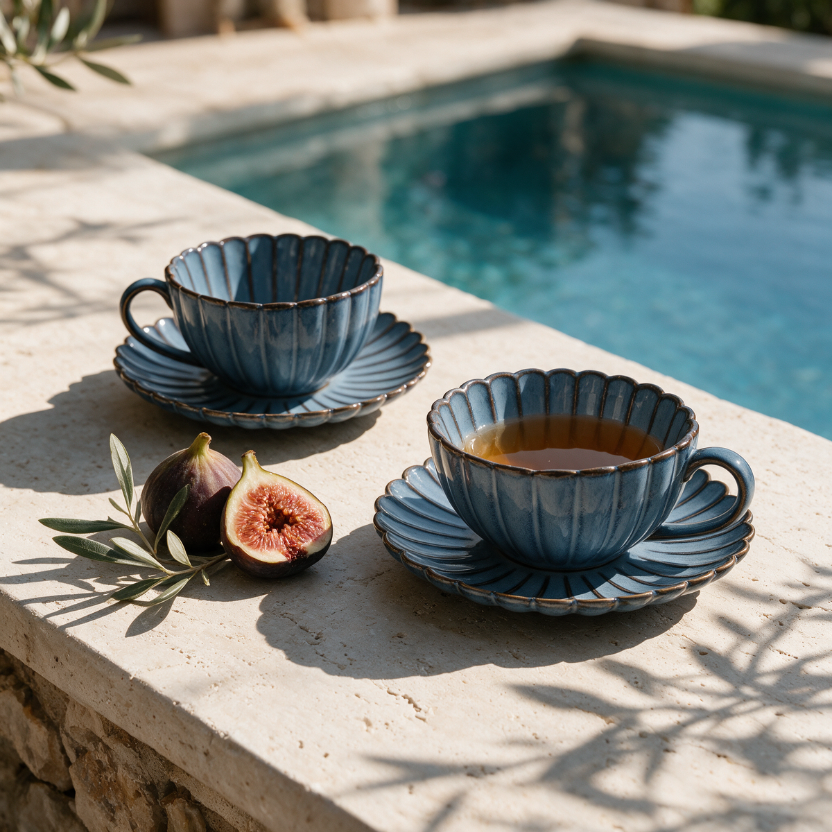 Hierro Ceramic Mugs with tea and figs on a travertine ledge at a stone villa pool