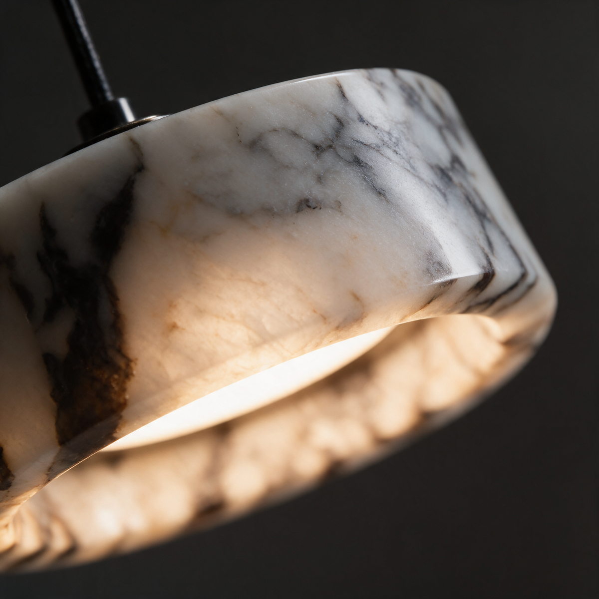 Close-up of the Aria Pendant Lamp marble shade lit from within, showing the natural veining