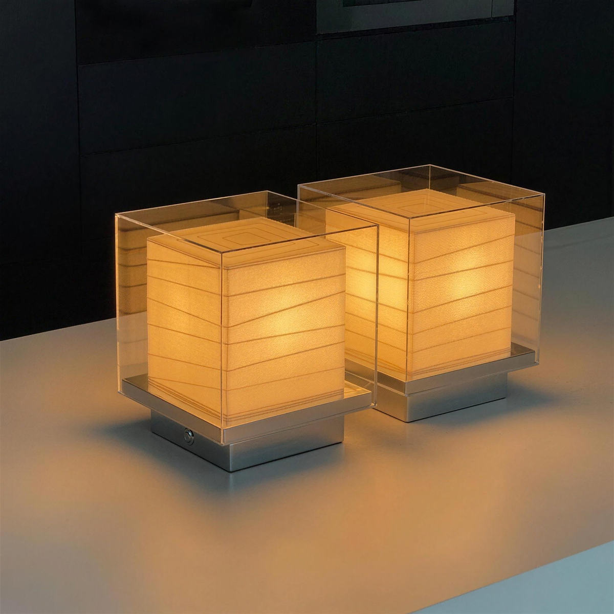 Two Kumo Table Lamps glowing side by side in a dark interior