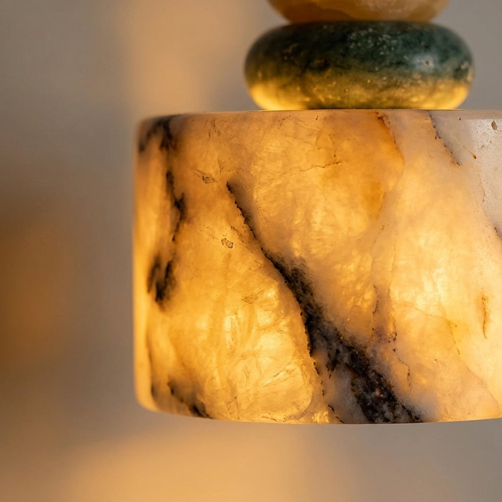 Cairn Pendant Lamp warm golden light through marble shade