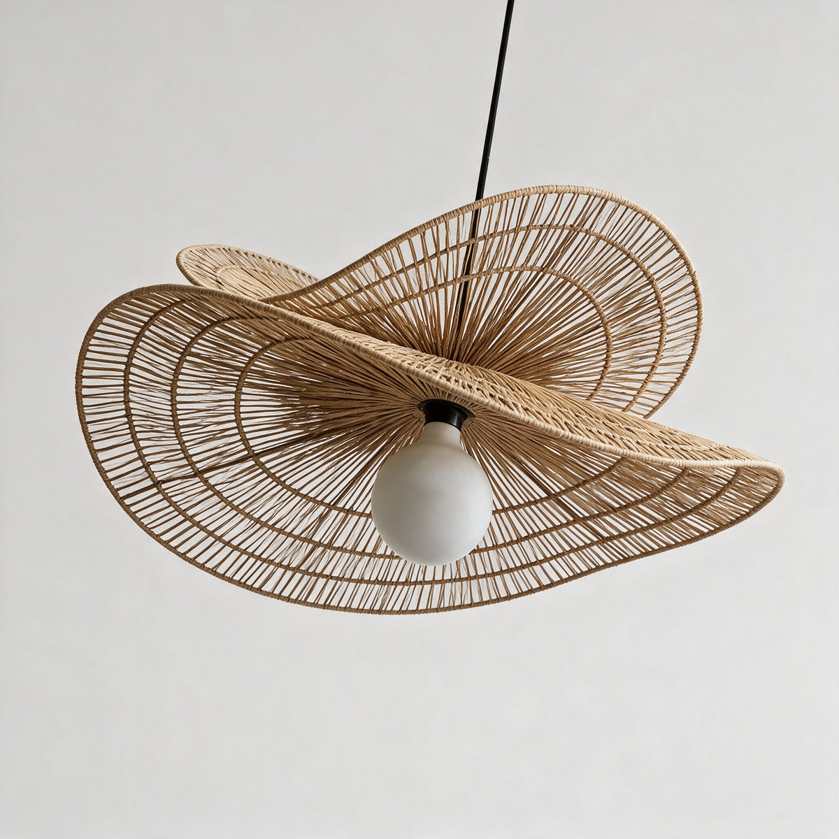Isla Chandelier seen from below, showing the radial rattan weave and globe bulb