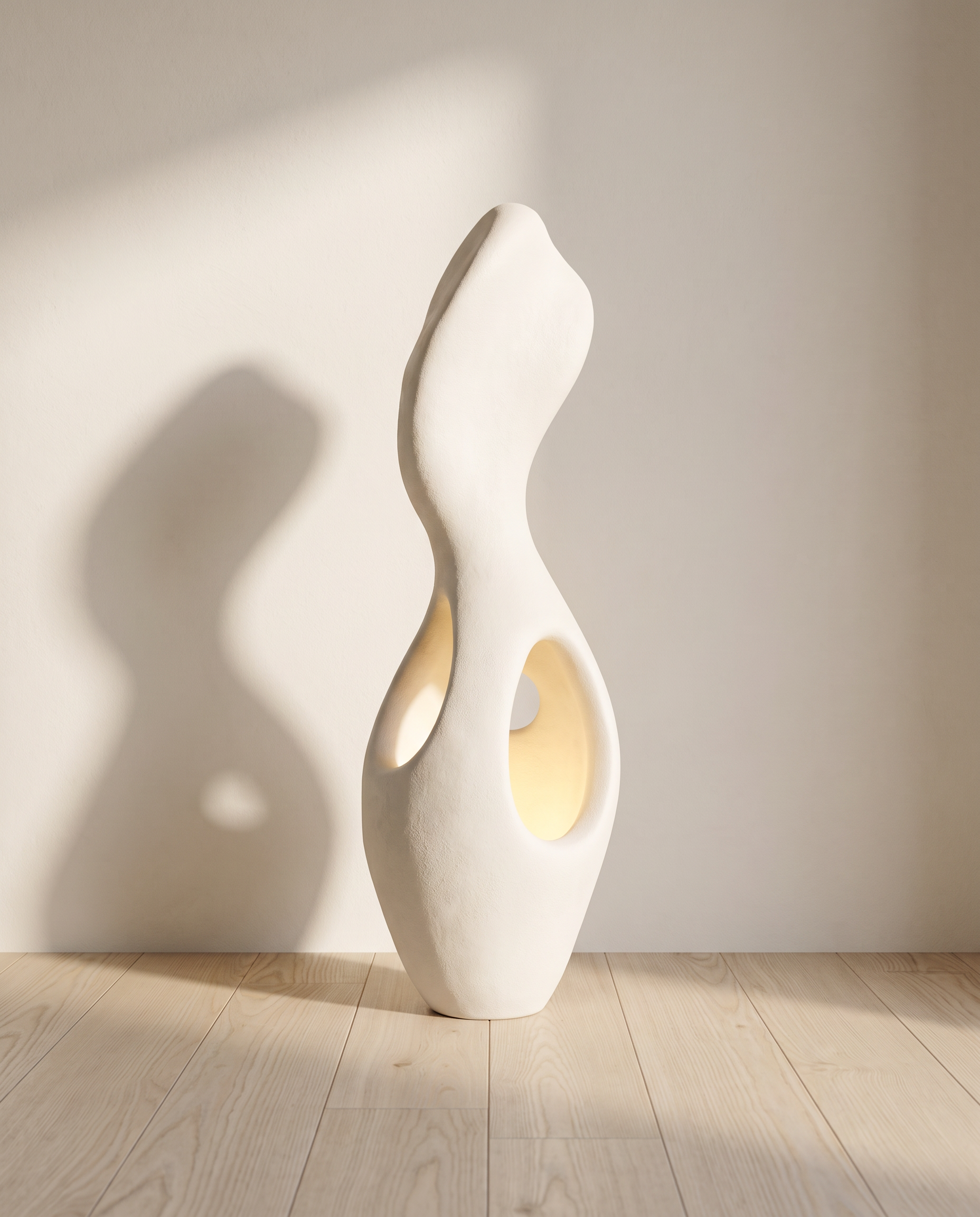 Martha floor lamp lit in a minimal Scandinavian room, warm glow through the hollow-out openings on an oak floor