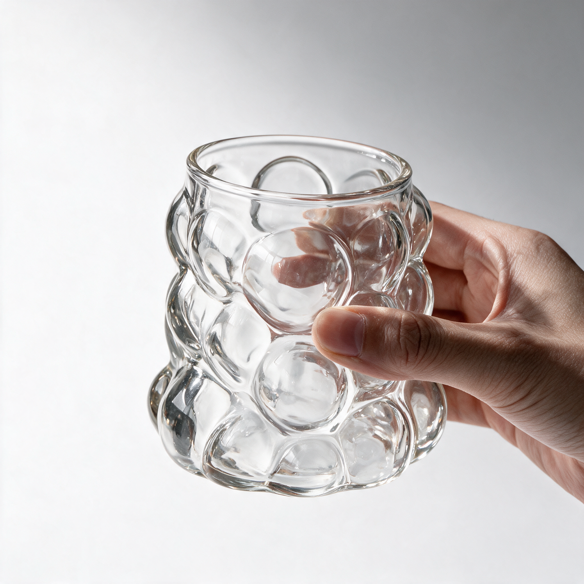 Bolla Glass Mug held in hand to show scale