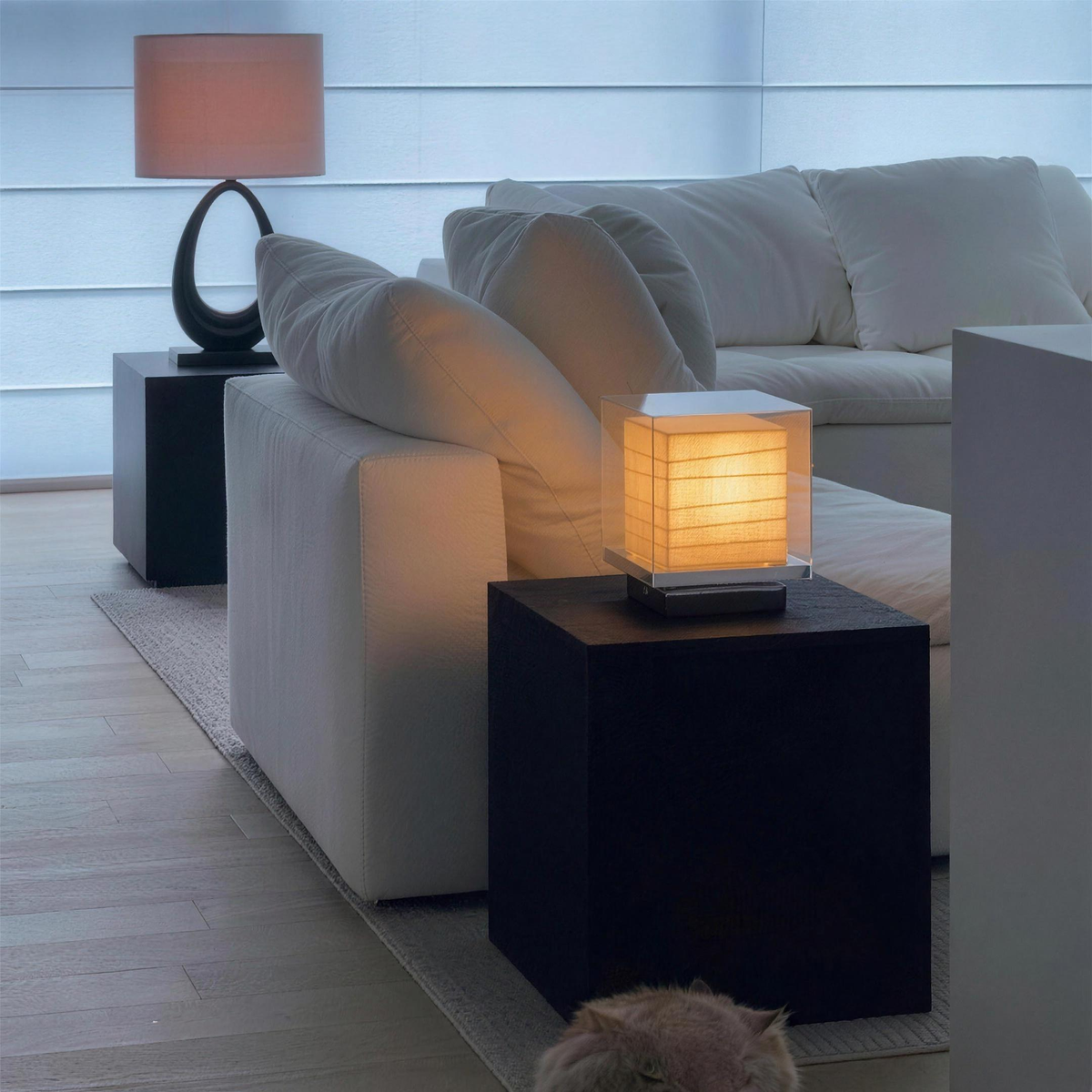 Kumo Table Lamp on a side table next to a white sofa