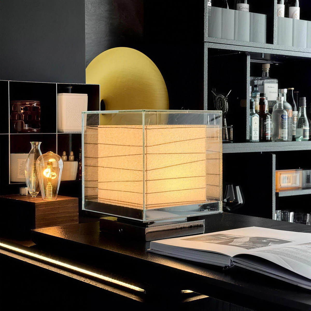 Kumo Table Lamp on a desk in front of a bookshelf