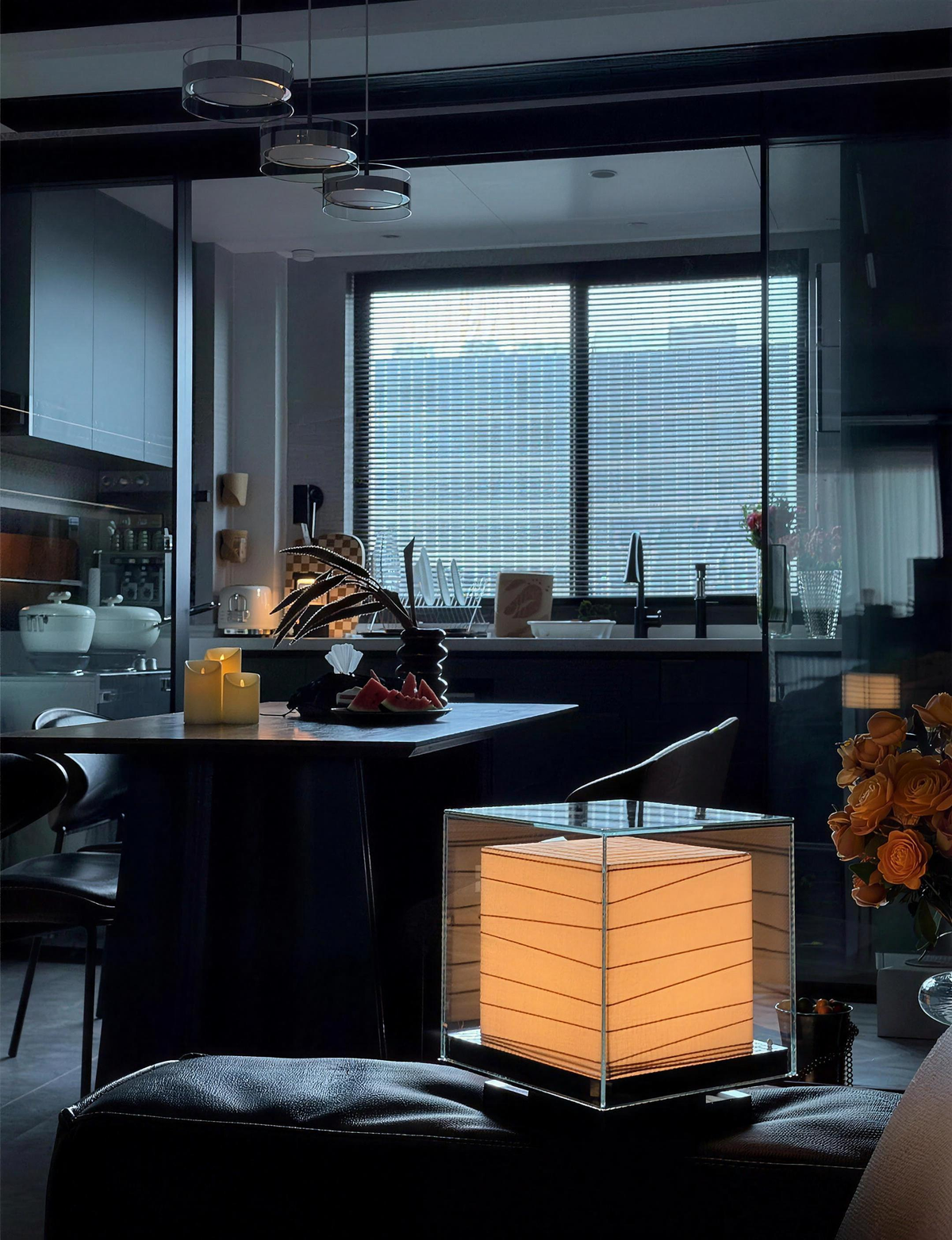 Kumo Table Lamp glowing in a modern living room at dusk