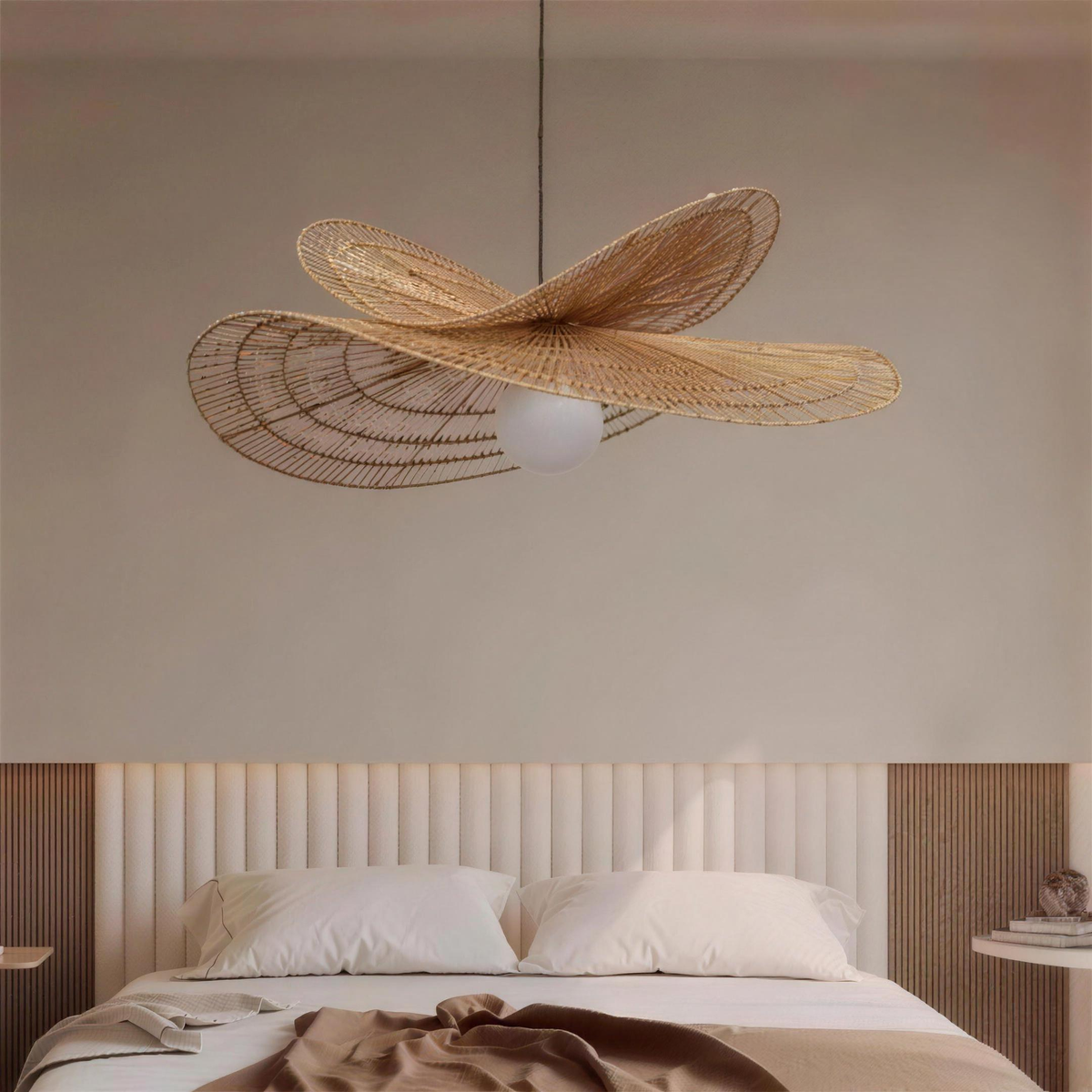 Isla rattan chandelier above a bed in a calm neutral bedroom